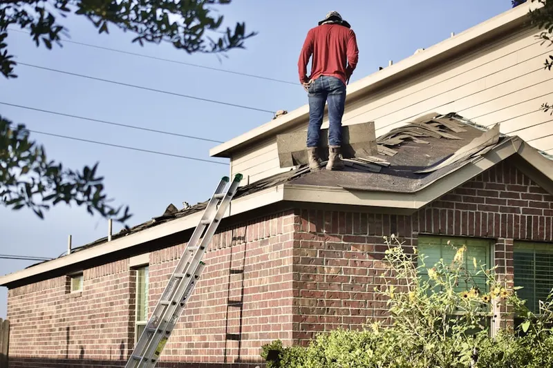 Professional roofer working on a residential roof in Butler Farms
